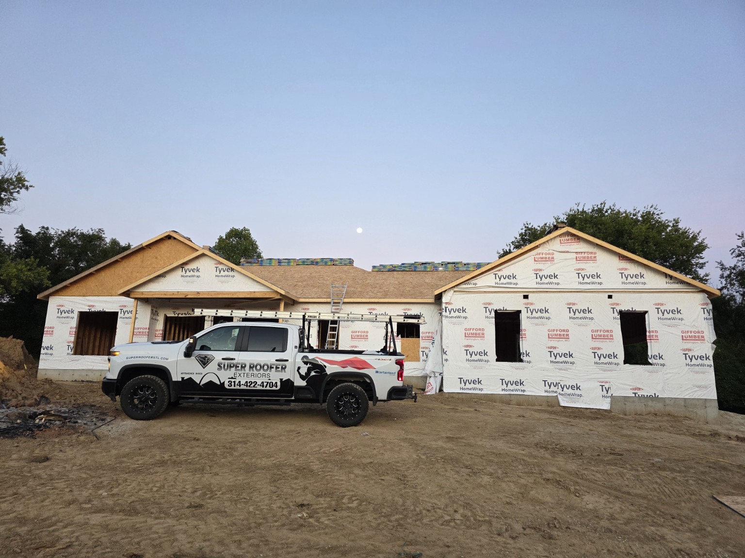 SuperRoofer Exteriors branded truck at completed Festus Missouri new-construction roofing project
